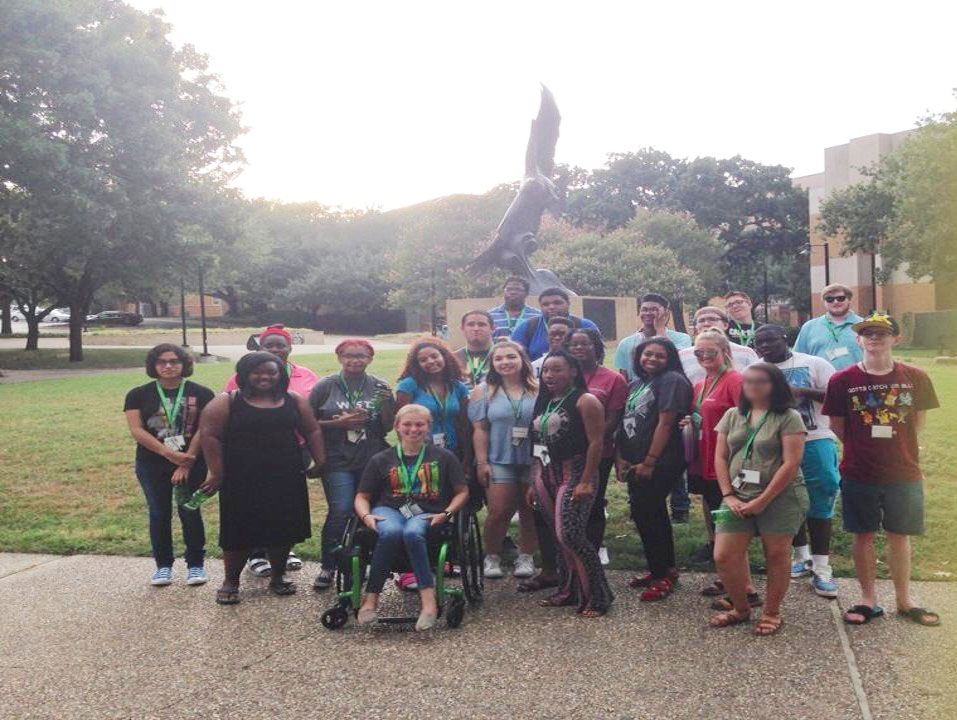 Group of participants in front of eagle statue at UNT.