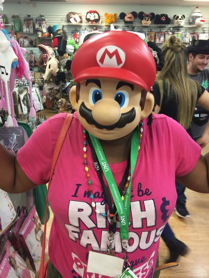 Participant wearing a Mario face mask at a local costume store. 