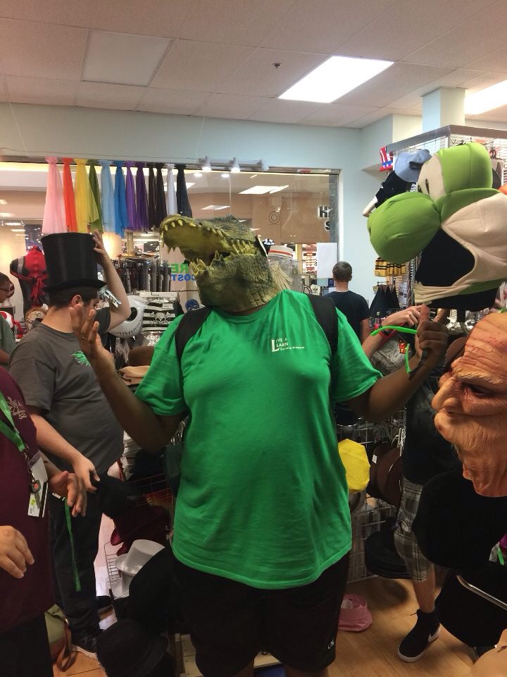 Participant wearing a alligator face mask at a local costume store. 
