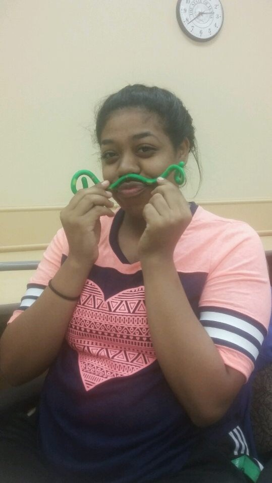 Participant making a mustache with a flexible manipulative. 