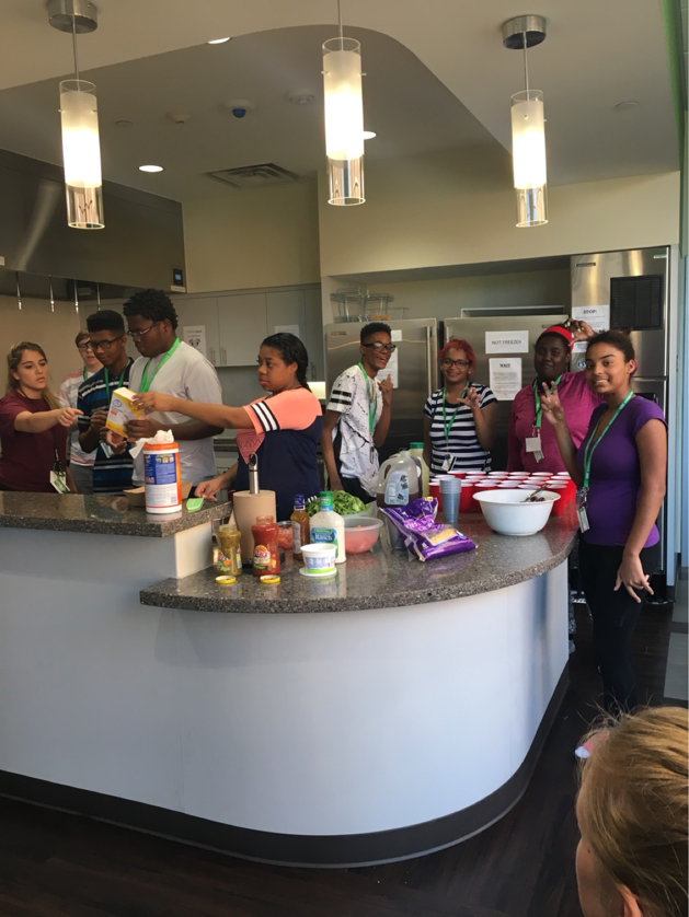 Participants gathered in the kitchen, preparing a meal. 